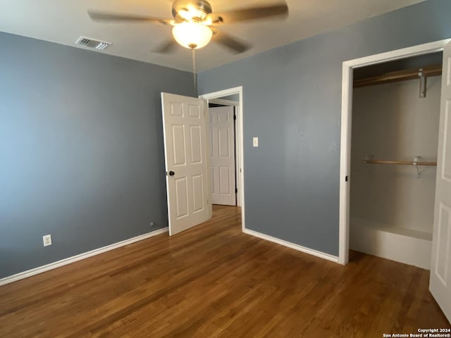 unfurnished bedroom featuring ceiling fan, dark hardwood / wood-style flooring, and a closet