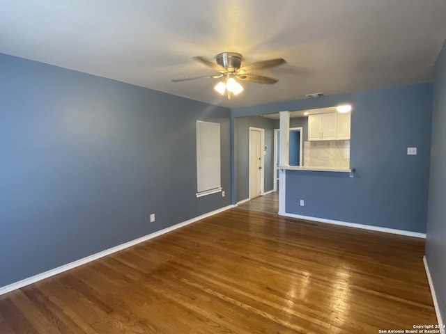 unfurnished room with ceiling fan and dark hardwood / wood-style flooring