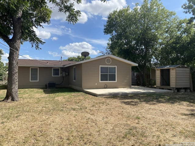 rear view of property with a patio area, a storage shed, and a lawn