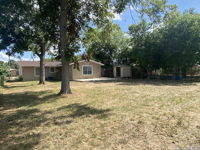 view of yard with central AC and a storage shed