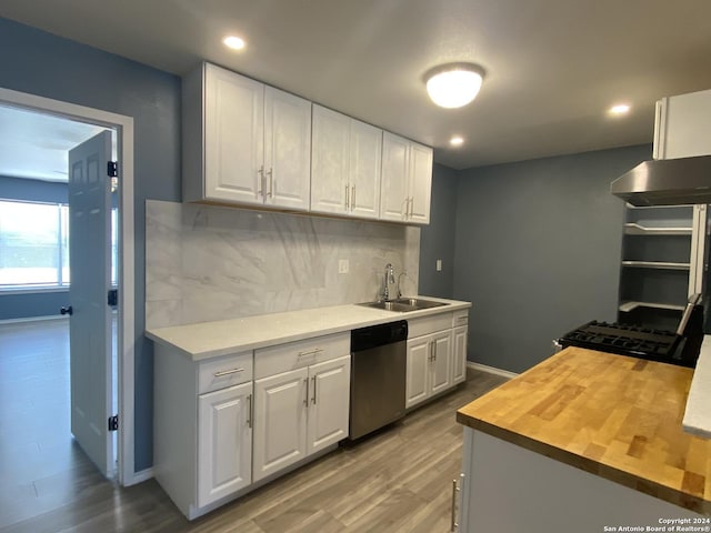 kitchen with backsplash, white cabinetry, dishwasher, and sink