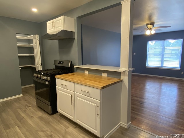 kitchen with wooden counters, gas range, ceiling fan, white cabinets, and hardwood / wood-style floors