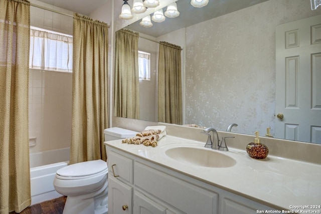 full bathroom with shower / tub combo with curtain, vanity, hardwood / wood-style flooring, and toilet