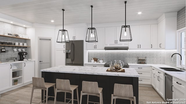 kitchen with a center island, appliances with stainless steel finishes, and tasteful backsplash