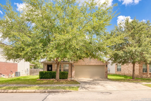 obstructed view of property with a garage, a front yard, and central air condition unit