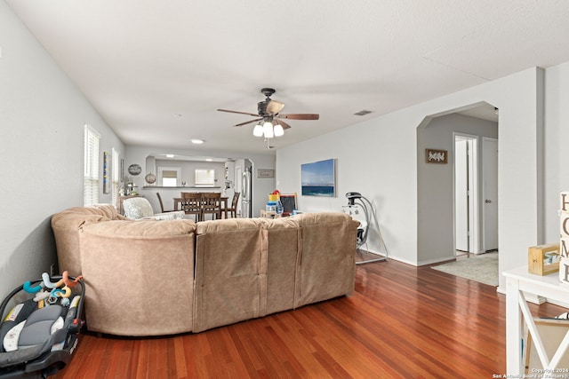 living room featuring ceiling fan and wood-type flooring