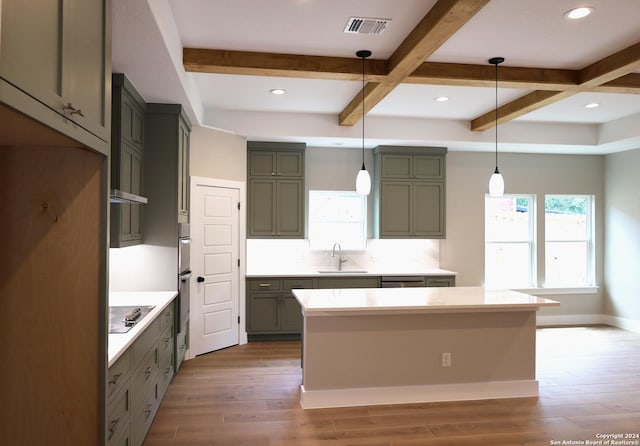 kitchen with beam ceiling, sink, pendant lighting, and dark hardwood / wood-style floors