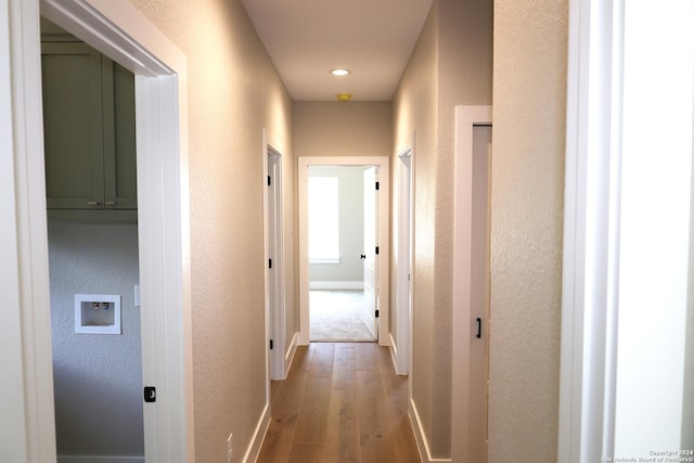 corridor with wood-type flooring