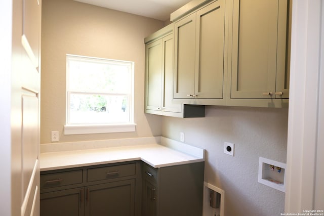 washroom featuring washer hookup, cabinets, and hookup for an electric dryer