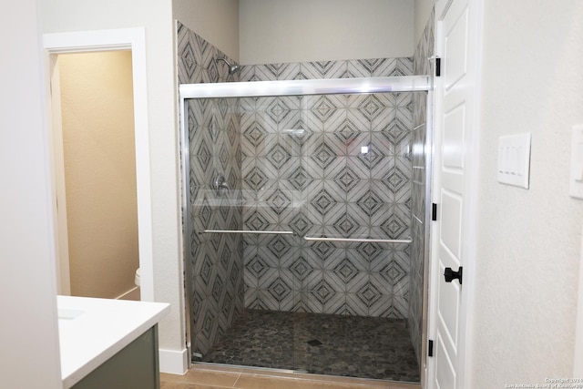 bathroom with tile patterned floors, vanity, and an enclosed shower