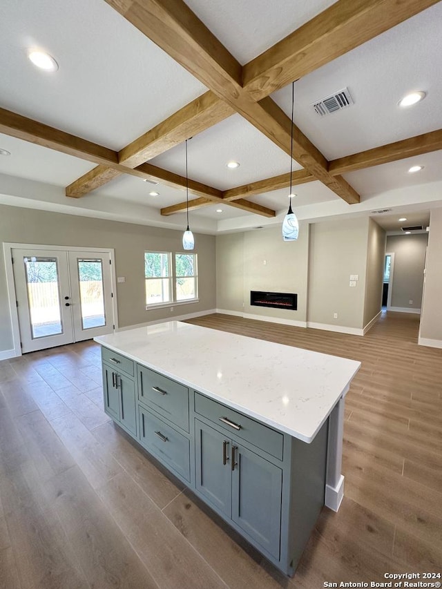 kitchen with pendant lighting, beam ceiling, coffered ceiling, and hardwood / wood-style floors