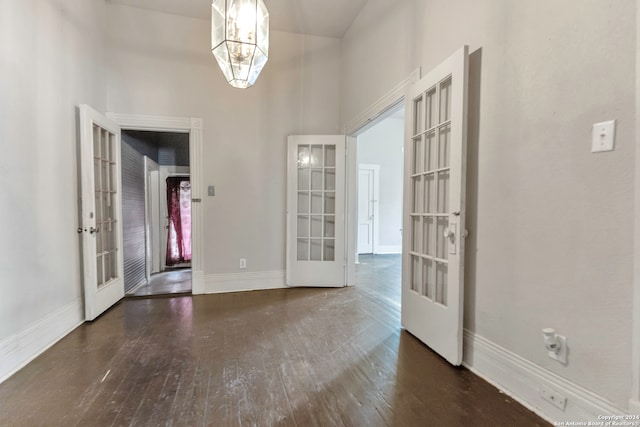 foyer entrance with a chandelier, french doors, and dark hardwood / wood-style flooring