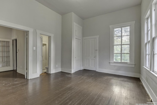 interior space featuring dark wood finished floors and baseboards