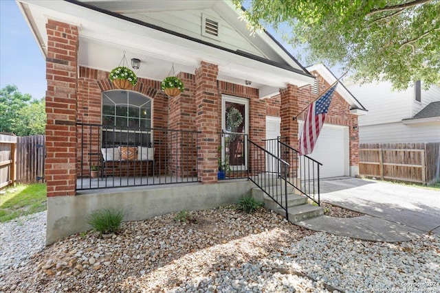 view of front facade featuring a porch and a garage