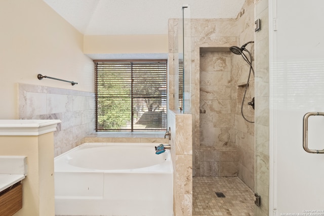 bathroom featuring independent shower and bath