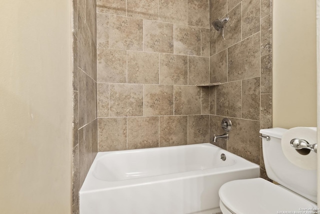 bathroom with toilet and tiled shower / bath combo