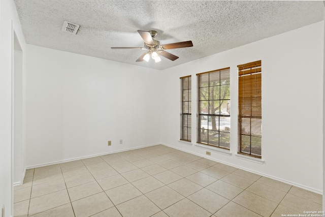 unfurnished room featuring ceiling fan, a textured ceiling, and light tile patterned floors