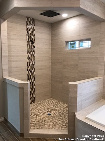 bathroom with tiled shower