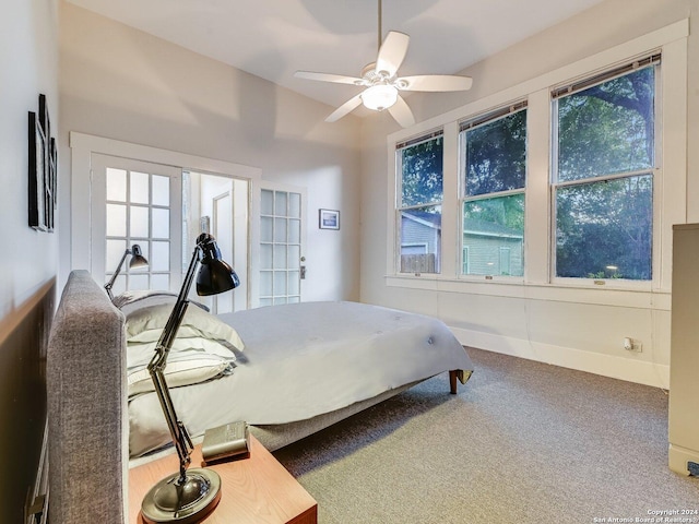 carpeted bedroom featuring ceiling fan and multiple windows