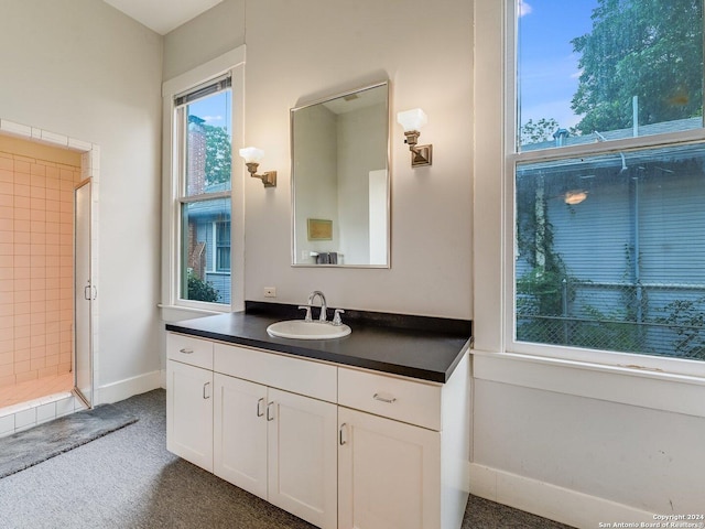 bathroom featuring a shower and vanity