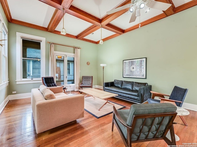 living room featuring french doors, coffered ceiling, ceiling fan, beamed ceiling, and light hardwood / wood-style floors