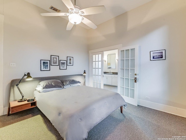 carpeted bedroom featuring ceiling fan, french doors, vaulted ceiling, and sink