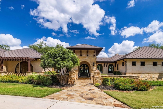 mediterranean / spanish-style house featuring a front yard