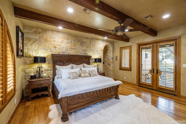 bedroom with hardwood / wood-style flooring, access to outside, french doors, and beamed ceiling