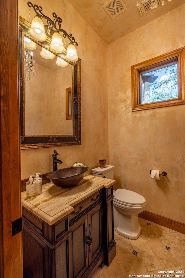 bathroom with vanity, toilet, and tile patterned flooring