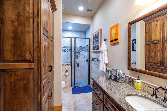 bathroom featuring vanity, toilet, and an enclosed shower