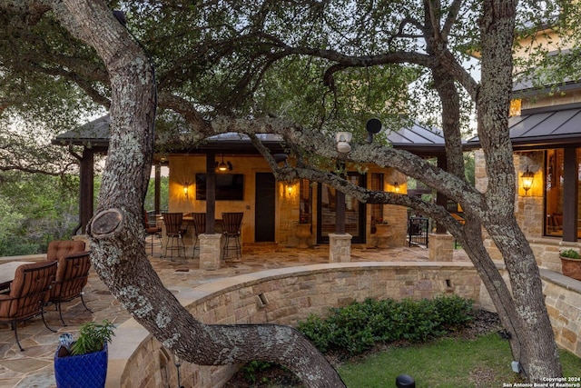 view of patio terrace at dusk