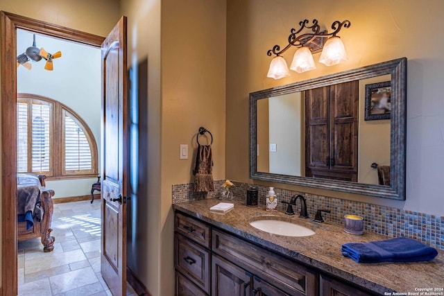 bathroom featuring tasteful backsplash and vanity