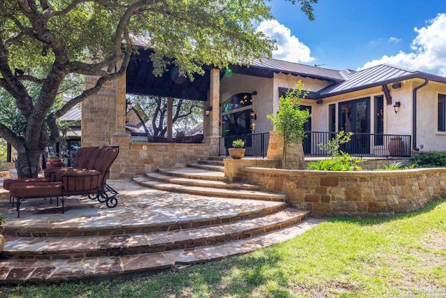 rear view of property featuring a patio area