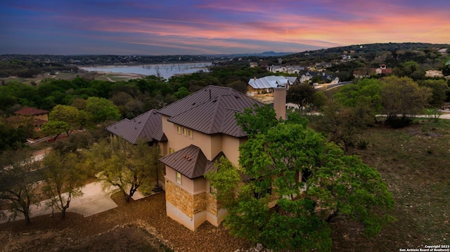 aerial view at dusk with a water view