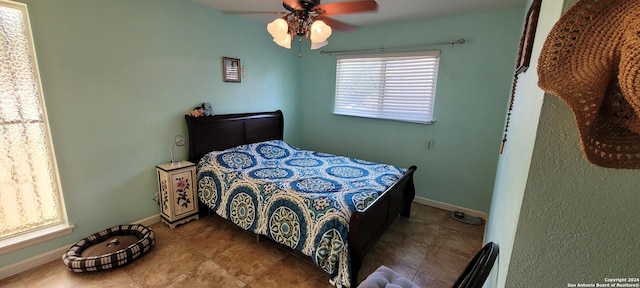 bedroom featuring ceiling fan, baseboards, and tile patterned floors