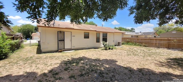 back of property with a fenced backyard