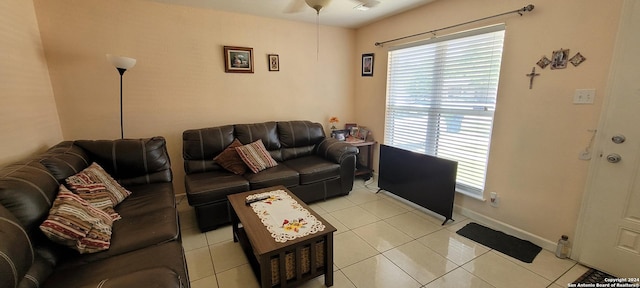 living room featuring light tile patterned floors and baseboards