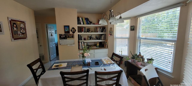 dining area with plenty of natural light, visible vents, a chandelier, and tile patterned flooring