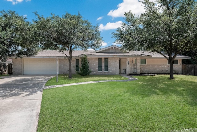 ranch-style home featuring a garage and a front lawn