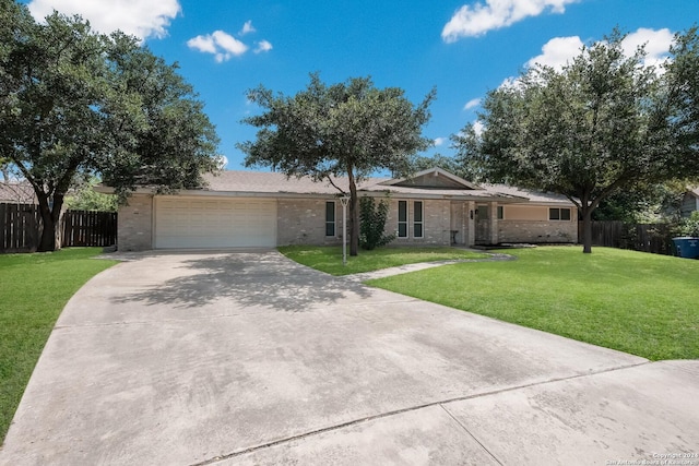 ranch-style house featuring a garage and a front lawn