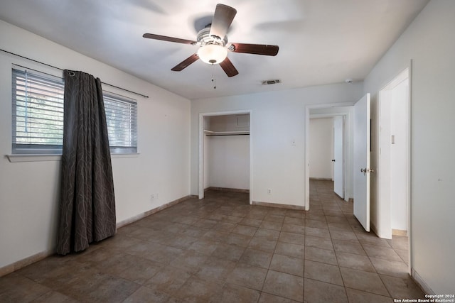 unfurnished bedroom featuring a closet and ceiling fan