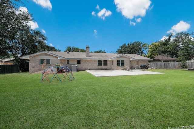 back of property featuring central AC unit, a patio area, and a lawn