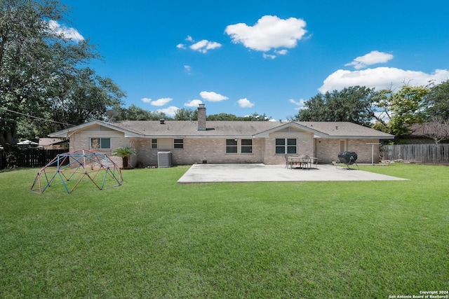 back of house with a lawn, central AC, and a patio