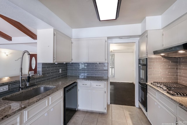 kitchen featuring stone countertops, white cabinetry, and black appliances