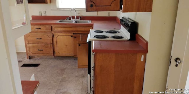 kitchen with sink, electric stove, and light tile patterned floors