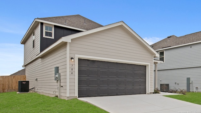 exterior space featuring a front yard, a garage, and central air condition unit