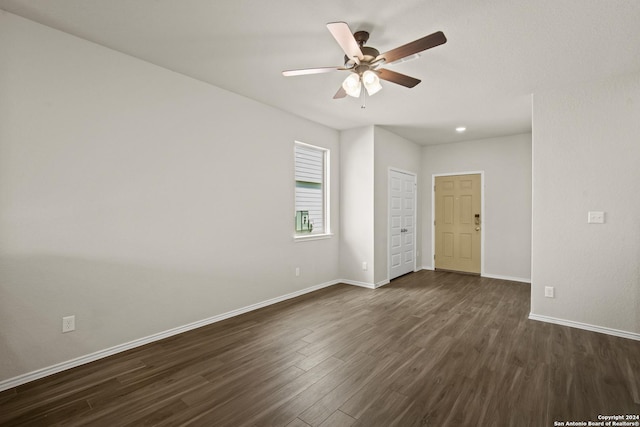 spare room featuring ceiling fan and dark hardwood / wood-style floors