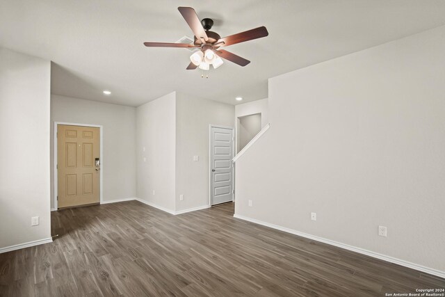 unfurnished room featuring ceiling fan and dark hardwood / wood-style flooring