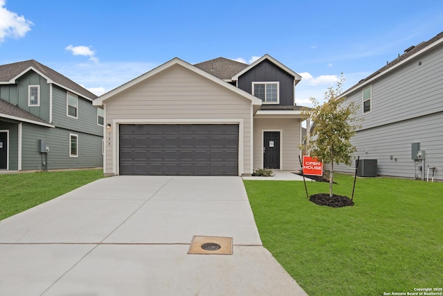 view of front facade with central AC, a garage, and a front yard