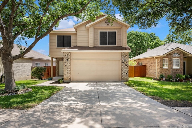 view of property featuring a garage and a front lawn